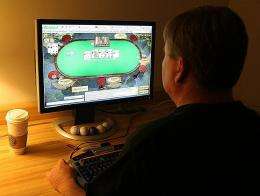 A man plays poker on his computer