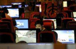 A man surfs the Internet at a coffee shop in Beijing