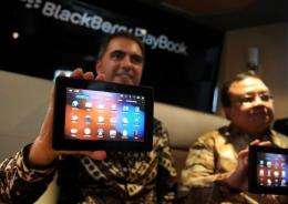 An official from Research in Motion (RIM) Indonesia displays a BlackBerry PlayBook