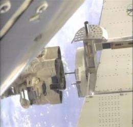 Astronauts install big magnet on space station (AP)