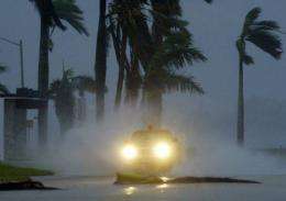 A trucks drives along a flooded street during a hurricane in Florida