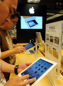 Customers check out the newly released Apple iPad 2 in Hong Kong