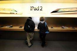 Customers try the latest Ipad 2 at the Apple store on Fifth Avenue in New York