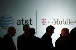 Executives at AT&T attend a news conference where it was announced that AT&T Inc. will be buying T-Mobile, in March