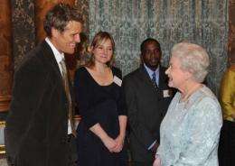 Queen Elizabeth II (R) speaks with James Cracknell and Alice Roberts (C)