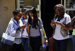 Students at Witwatersrand University in Johannesburg use their mobile phones