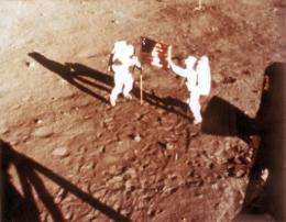 US astronauts Neil Armstrong and "Buzz" Aldrin deploy the US flag on the Moon in 1969