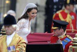 Prince William (R) and his wife Kate, Duchess of Cambridge climb into a carriage after their wedding service in London