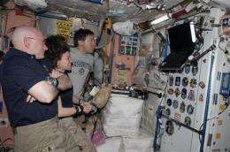 2 space crews mark 1 week together in orbit (AP)