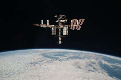 The International Space Station and the docked space shuttle Endeavour flying at an altitude of approximately 220 miles