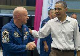 US President Barack Obama speaks with Astronaut Mark Kelly at the Kennedy Space Center