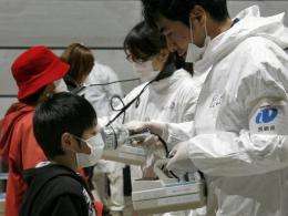 A boy receives a radiation scan at a screening center in Koriyama in Fukushima prefecture in March