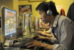 A chinese man plays online games at an internet cafe