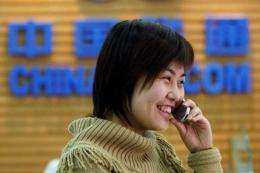 A customer makes a call at a China Unicom office in Beijing