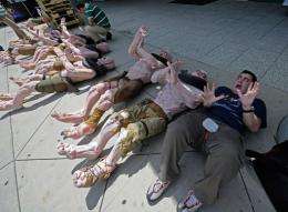 Adam Ghiggio from Australia poses next to mutant mannequins wich are lined up to be used as displays for "Rage"