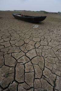 A fishing boat lies on the dried up bank of the Chaohu lake