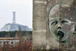 A graffiti is pictured on a wall in the ghost city of Pripyat near the former Chernobyl Nuclear power plant (background)