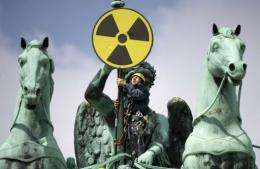 A Greenpeace activist places an anti-nuclear sign on top of the Brandenburg Gate in Berlin
