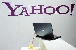 A laptop is seen under the logo of Yahoo
