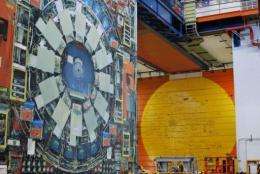 A life-sized photo of the Tevatron particle accelerator's detector hangs from a beam