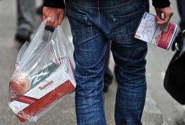 A man holds a plastic bag