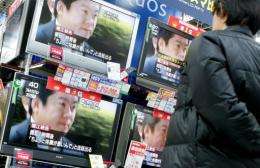 A man looks at a television news report on former Livedoor Co. President Takafumi Horie at an electronics shop in Tokyo