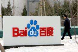 A man walks by a sign for China's top Internet search engine Baidu's office in Beijing