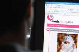 A Moroccan looks at an Internet page of a marriage dating site