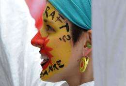 An anti-nuclear demonstrator with her face painted takes part in a protest march in Munich