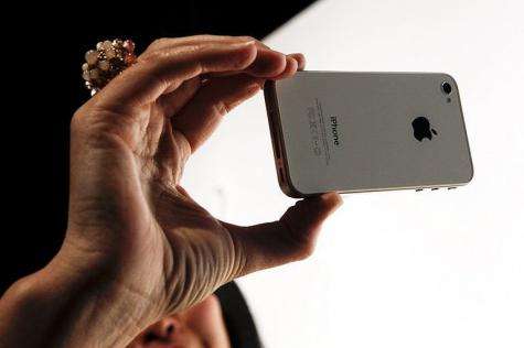 An Apple Inc. employee checks the iPhone 4