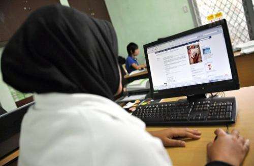 An Indonesian Muslim woman using popular social networking website Facebook in Jakarta