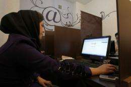 An Iranian woman surfs the Internet at a cyber cafe in central Tehran