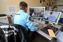 A policeman in Lille, France, works on cyber crime
