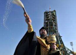A Russian Orthodox priest blesses the Soyuz TMA-22 spacecraft at Russia's Baikonur cosmodrome