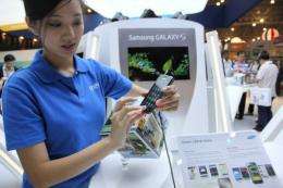 A Samsung marketing promoter demonstrates one of the new smartpones powered by Google's Android operating system