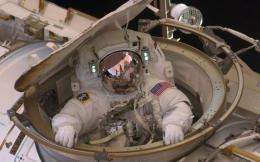 Astronaut Drew Feustel re-enters the space station after completing an 8-hour, 7-min spacewalk