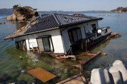 A washed up house stands on the shoreline in Onagawa, Miyagi prefecture in April