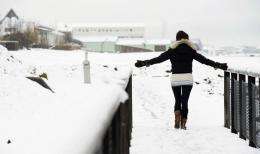 A woman stands in the snow in the center of Reykjavik