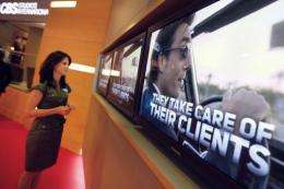 A woman watches screens  in Cannes, southern France, during the MIPTV trade show