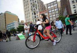 A young New York resident takes a test ride as part of a demonstration of a new bicycle sharing system