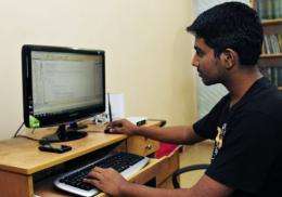 Bangladeshi computer programmer Abdullah Al Zahid works on his computer at his house in Dhaka