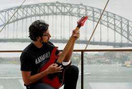 Brazilian guitar soloist Paulo Calligopoulos, with the Sydney Harbour Bridge in the background