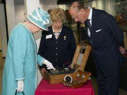 Britain's Queen Elizabeth II (left) starts the wartime Enigma codebreaking machine at Bletchley Park in July