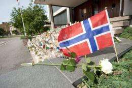 Candles are lit at the doorstep of the Norwegian Embassy in Helsinki