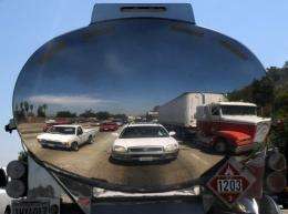 Cars stuck in traffic are reflected in a truck on freeway 110 in Los Angeles, California