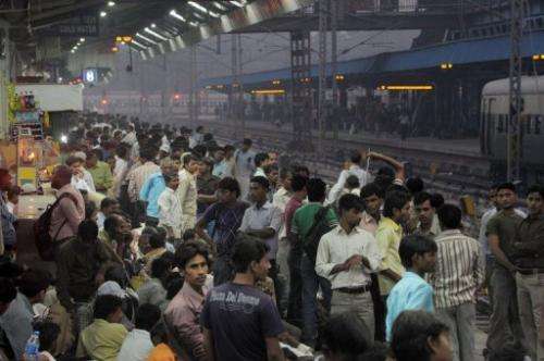 Commuters crowd a platform at a train station in downtown New Delhi