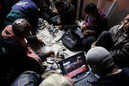 Egyptian anti-government bloggers work on their laptops from Cairo's Tahrir square in February