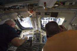 Endeavour astronauts stroll out for spacewalk (AP)