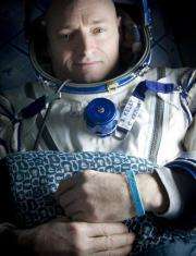 Giffords wristband worn by husband's twin in space (AP)