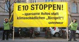 Greenpeace activists display a banner reading: "Stop E10, economic cars instead of harmful fuel"